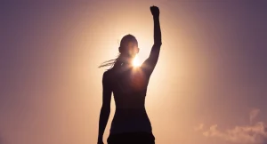 Profile of woman with hand raised in triumph