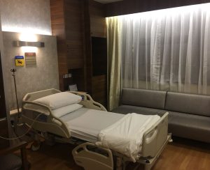 Modern hospital room with bed and sofa